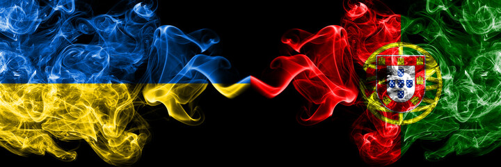 Ukraine, Ukrainian vs Portugal, Portuguese smoky mystic flags placed side by side. Thick colored silky abstract smokes flags.