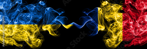 Ukraine, Ukrainian vs Romania, Romanian smoky mystic flags placed side by side. Thick colored silky abstract smokes flags.