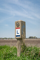 Lincoln highway marker in the spring sunshine.  Franklin Grove, Illinois, USA.