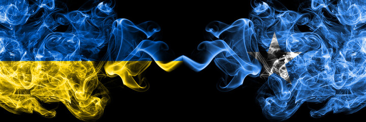 Ukraine, Ukrainian vs Somalia, Somali smoky mystic flags placed side by side. Thick colored silky abstract smokes flags.