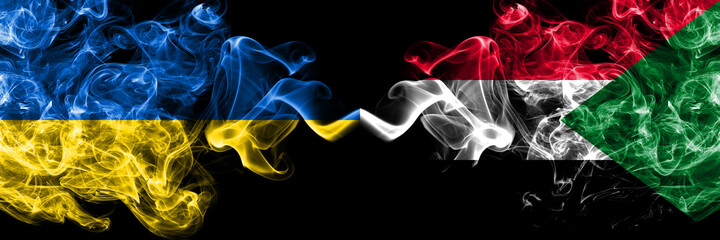 Ukraine, Ukrainian vs Sudan smoky mystic flags placed side by side. Thick colored silky abstract smokes flags.