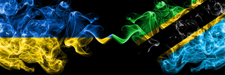 Ukraine, Ukrainian vs Tanzania smoky mystic flags placed side by side. Thick colored silky abstract smokes flags.