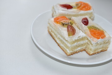White fruit delicious cake on a white plate