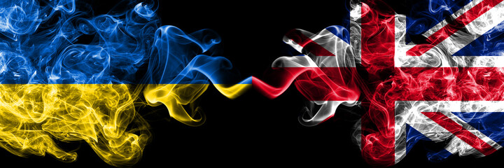 Ukraine, Ukrainian vs United Kingdom, Great Britain, British smoky mystic flags placed side by side. Thick colored silky abstract smokes flags.