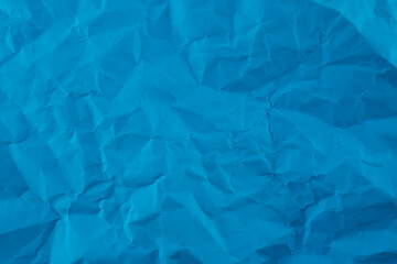 Wrinkled blue paper fragment as a background texture