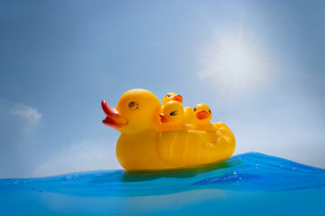 A floating mother of rubber ducks with three young children
