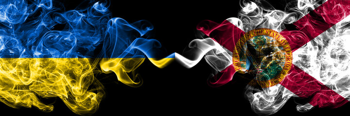 Ukraine, Ukrainian vs United States of America, America, US, USA, American, Florida smoky mystic flags placed side by side. Thick colored silky abstract smokes flags.