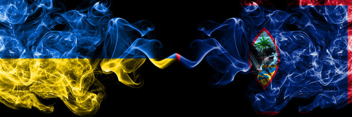 Ukraine, Ukrainian vs United States of America, America, US, USA, American, Guam smoky mystic flags placed side by side. Thick colored silky abstract smokes flags.