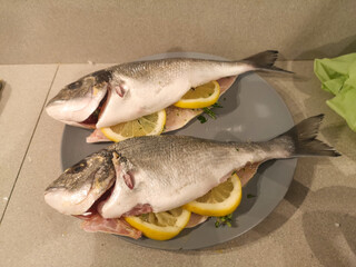 grilled sead fish sea bream fish cleaned and seasoned with lemon ready for cooking
