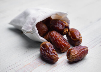 Fruits of date palm Phoenix dactylifera on white wood,Dried dates