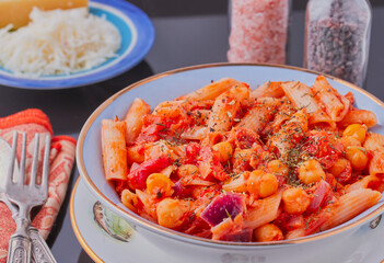 Tuna and pasta dish garnished with herbs.