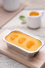 Orange fudge cake or orange glazed cakes in the aluminium foil box