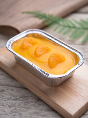 Orange fudge cake or orange glazed cakes in the aluminium foil box