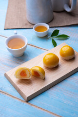 Chinese pastry puff, Beans cake with salted egg yolk lay on table wood,Homemade bakery concept.