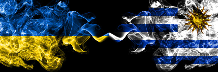 Ukraine, Ukrainian vs Uruguay, Uruguayan smoky mystic flags placed side by side. Thick colored silky abstract smokes flags.