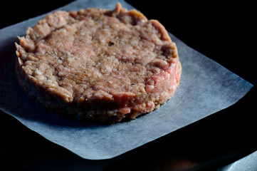 Home made hand pressed raw beef burger on grease paper