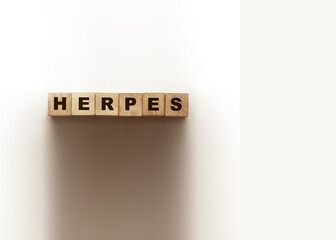 HERPES word made with wooden blocks on white. Healthcare concept
