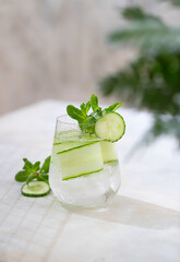 Detox cocktail cucumber and mint on a light background. Healthy nutrition diet concept. Homemade lemonade. Cold and refreshing detox water.