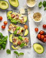 crispbread with avocado, tomatoes and basil and parmesan