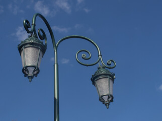 Fototapeta na wymiar Decorative lamp in the park on a blue sky ,retro park lamp
