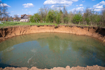 A huge sinkhole in the middle of the field