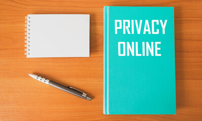 The diary says: ONLINE PRIVACY. There is a notepad and a pen on a wooden table.