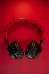 Fototapeta na wymiar Red background with black headphones