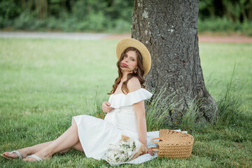 Obraz premium Portrait of a beautiful young pregnant woman in nature. Happiness.