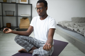 Body, mental health, attention and concentration. Handsome peaceful young black male in pajamas...