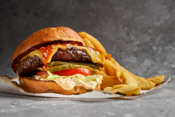 American cuisine. Royal Cheese Burger of Marble Beef with cucumbers, cheese and sauce. Healthy, tasty, nourishing snack