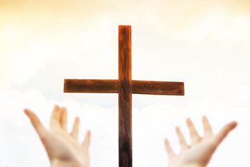 Hands on the background of the cross. Hands praise God. Blank cross against the sky. Real Easter....