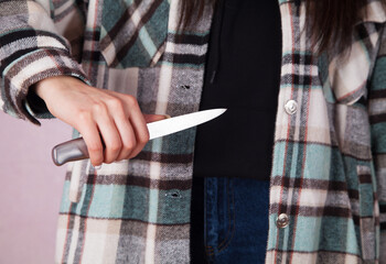 Woman is trying to harm herself with a knife. Suicide.