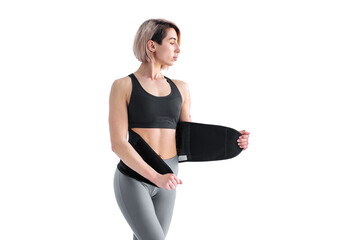 Girl doing fitness back belt slimming isolated on white backgrou