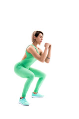 Obraz premium Studio shot of an athletic woman doing squats isolated over whit