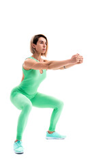 Studio shot of an athletic woman doing squats isolated over whit