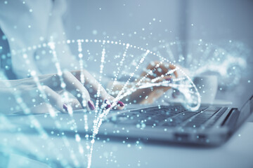 Double exposure of woman hands typing on computer and DNA hologram drawing. Medical education concept.