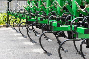 Fototapeta na wymiar New plow machine standing outdoor at agro exhibition