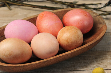 painted easter eggs in a wooden plate