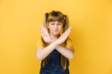 Serious displeased girl child look at camera show stop gesture sign, dissatisfied unhappy kid makes...