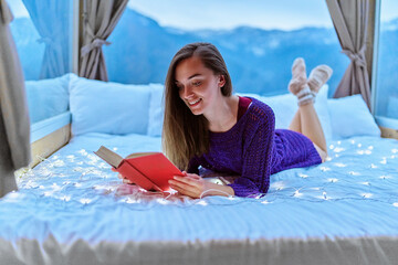 Young beautiful charming happy cute smiling romantic woman passionate about reading exciting book...
