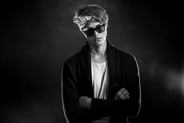 Fototapeta premium Cool stylish man in black jacket and sunglasses. High Fashion ma