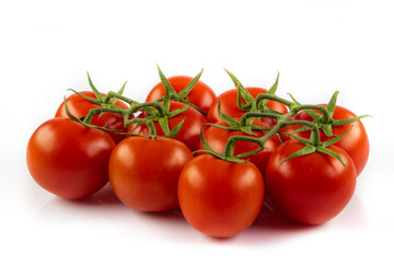 Fresh cherry tomatoes with a sprig isolated on a white background. Tomato branch. Fresh tomatoes with green leaves.