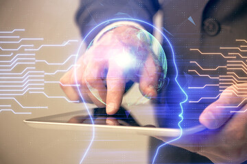 Double exposure of man's hand holding and using a digital device and brain hologram drawing. Data concept.