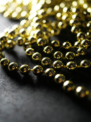 gold silver pearl beads on a dark background, on a dark table