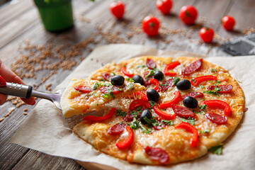 Woman holding piece of pizza