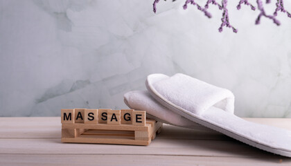 word massage on table  spa salon in Natural Background. Spa treatment.  Copy space. Selective focus.	