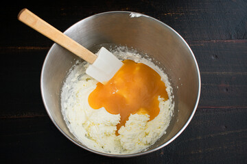 Mixing Lemon Curd and Whipped Cream: Folding lemon curd into whipped cream with a spatula - Powered by Adobe