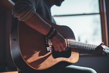 Musician playing on acoustic guitar © Jacek Dylag