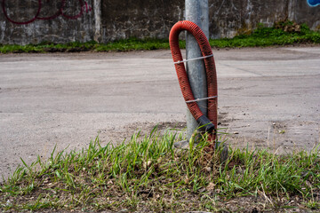 a red tube tied to a lamppost