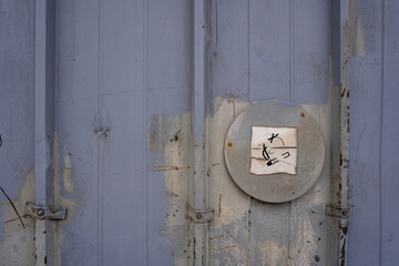 a warning sign affixed to an old metal door